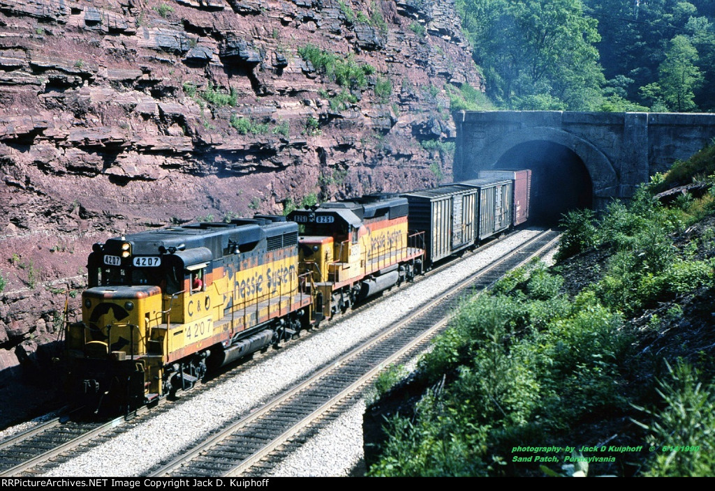 Chessie, C&O GP30 4207- CSXT SD40 8251 exit the tunnel westbound at the crest of Sand Patch grade on the ex-B&O Keystone sub. Sand Patch, Pennsylvania. June 14, 1990. 